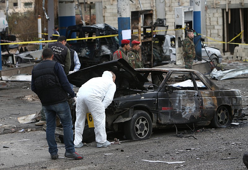 In this Feb. 2, 2014, file photo, Lebanese police inspectors, investigates the site of a deadly car bomb that exploded near a gas station, in the predominately Shiite town of Hermel, about 10 miles from the Syrian border in northeast Lebanon.