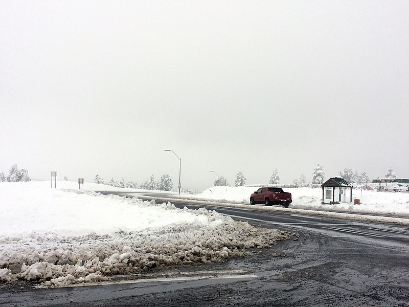 Snow covers the ground in Flagstaff, Ariz., Sunday, March 1, 2015. Snow and rain soaked parts of northern and central Arizona on Sunday, while a storm in California began to drift into the state's southern region.