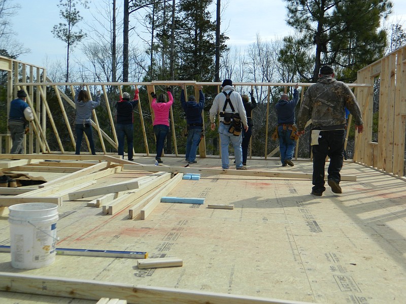 Volunteers associated with Habitat for Humanity of Cleveland's Women Build 2015 program raise a wall of a new home in the Southgate Hills subdivision, located near South Lee Highway.
