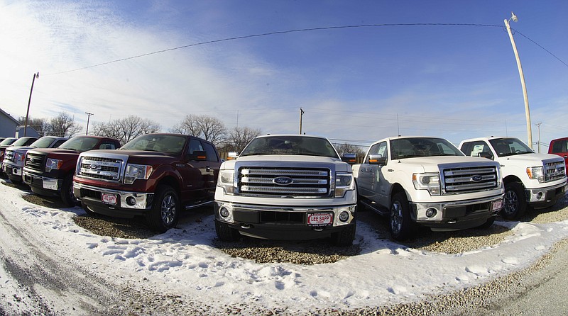 In this Jan. 13, 2015, file photo, Ford F-150 pickup trucks are lined up at the Lee Sapp Ford dealership in Ashland, Neb.eet demand for the new F-150 pickup truck.
