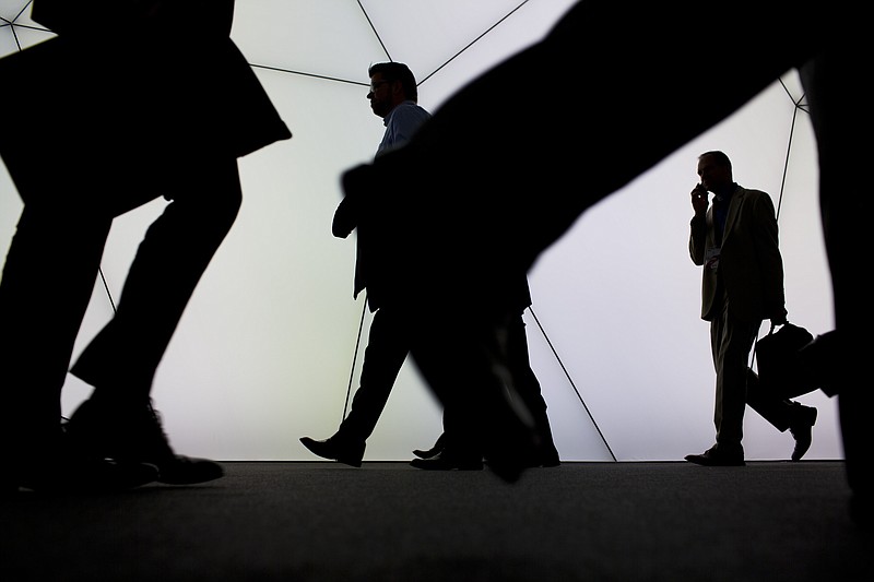 
              Visitors walk inside a pavilion at the Mobile World Congress, the world's largest mobile phone trade show in Barcelona, Spain, Tuesday, March 3, 2015. (AP Photo/Emilio Morenatti)
            