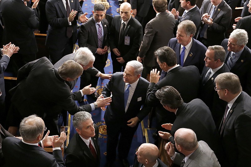 
              Israeli Prime Minister Benjamin Netanyahu shakes hands as he leaves the House chamber on Capitol Hill in Washington, Tuesday, March 3, 2015, after addressing a joint meeting of Congress. In a speech that stirred political intrigue in two countries, Netanyahu told Congress that negotiations underway between Iran and the U.S. would "all but guarantee" that Tehran will get nuclear weapons, a step that the world must avoid at all costs. (AP Photo/Andrew Harnik)
            