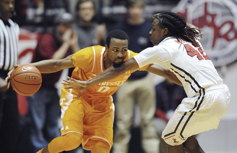Tennessee guard Kevin Punter (0) is defended by Mississippi guard Stefan Moody (42) during an NCAA college basketball game Saturday, Feb. 21, 2015 in Oxford, Miss.