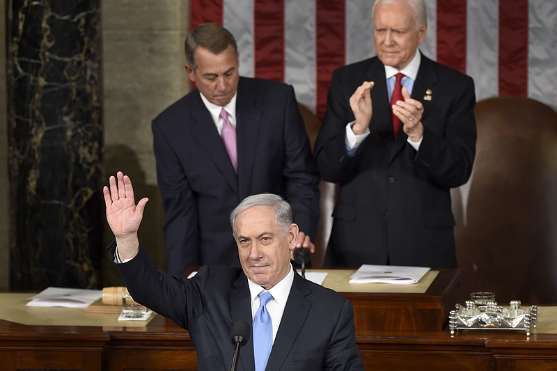 Israeli Prime Minister Benjamin Netanyahu waves as he speaks before a joint meeting of Congress on Capitol Hill.