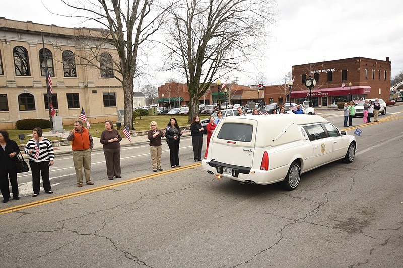 People of the town of Jasper, Tenn. turn out to pay respects as the remains of U.S. Army Pfc. Lotchie Jones moves past the courthouse and Jasper Drug Co., where he boarded a bus for the War in Korea in 1950.