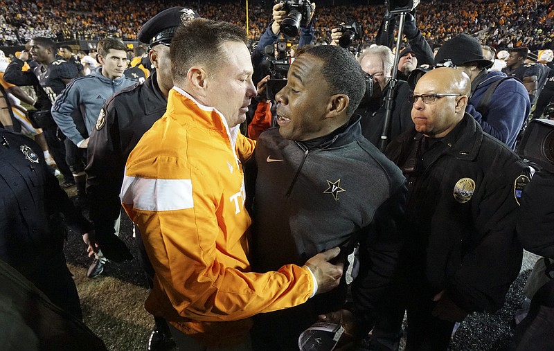 Vandy's head coach Derek Mason, right, congratulates UT's head coach Butch Jones and tells him to represent the state of Tennessee well in his bowl game after the Volunteers defeated the Commodores in this Nov. 29, 2014, photo.