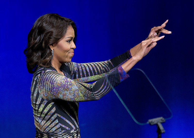 
              First lady Michelle Obama waves while speaking at the Newseum in Washington, Wednesday, March 4, 2015, to launch the "Change Direction" campaign. Michelle Obama says mental health care is not just a policy and budget issue for America, but also a cultural issue. The first lady says there should be  no stigma around mental health, and the real change requires a shift in "our attitudes." Mrs. Obama spoke Wednesday at a mental health summit and the national launch of the campaign to "Change Direction."    (AP Photo/Manuel Balce Ceneta)
            