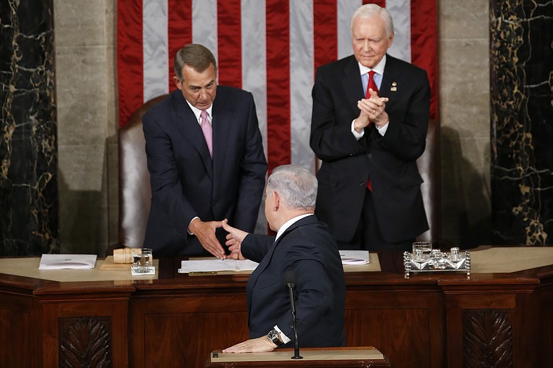 
              Israeli Prime Minister Benjamin Netanyahu turns and shake hands with House Speaker John Boehner of Ohio hand after addressing a joint meeting of Congress on Capitol Hill in Washington, Tuesday, March 3, 2015. In a speech that stirred political intrigue in two countries, Netanyahu told Congress that negotiations underway between Iran and the U.S. would "all but guarantee" that Tehran will get nuclear weapons, a step that the world must avoid at all costs. Sen. Orrin Hatch, R-Utah applauds at right.  (AP Photo/Andrew Harnik)
            