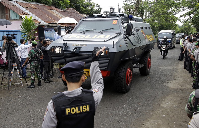 
              One of Indonesian police armored vehicles carrying two Australian prisoners arrives at Wijaya Pura port in Cilacap, Central Java, Indonesia, Wednesday, March 4, 2015. Indonesia began transferring the two Australians Andrew Chan and Myuran Sukumaran early Wednesday in preparation for the execution by firing squad of nine foreigners and an Indonesian condemned for drug smuggling, as diplomatic squabbles persist over the executions. (AP Photo/Achmad Ibrahim)
            