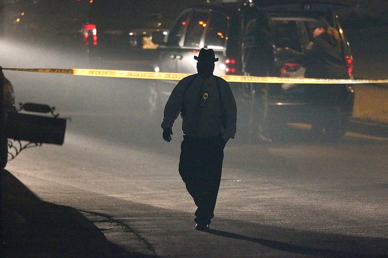Authorities investigate the scene of a police shooting, early Wednesday, March 4, 2015, near Fairburn, Ga. A Fulton County police officer was shot and killed in what authorities describe as an ambush.