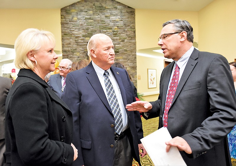 CEO Greg Vital, right, talks with Sherri, left, and John Shackleford Thursday at the grand opening of Morning Pointe on Shallowford Road.