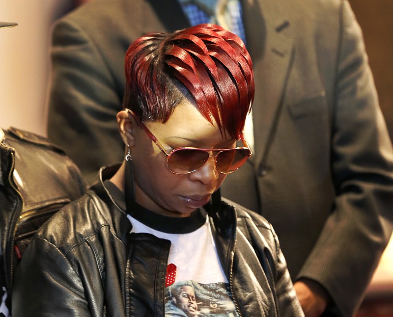 
              Lesley McSpadden, mother of Michael Brown Jr., listens to the family attorney during a news conference, Thursday, March 5, 2015, in Dellwood, Mo. Neither McSpadden nor Brown's father, Michael Brown Sr., spoke or took questions. The Justice Department on Wednesday cleared former Ferguson, Mo., police Officer Darren Wilson in the fatal shooting of Michael Jr., but also issued a scathing report calling for sweeping changes in city law enforcement practices it called discriminatory and unconstitutional. (AP Photo/Charles Rex Arbogast)
            