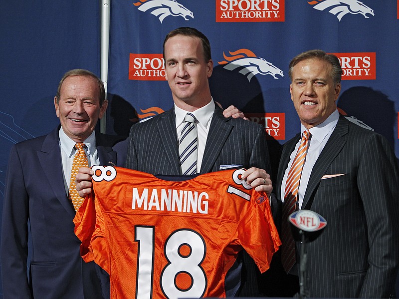 Denver Broncos quarterback Peyton Manning, center, is flanked by Broncos owner Pat Bowlin, left, and vice president John Elway during a news conference at the NFL Denver Broncos headquarters in Englewood, Colo., in this 2012, file photo.