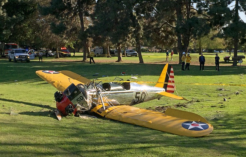 A small plane lies where it crash-landed on Penmar Golf Course in the Venice area of Los Angeles on Thursday, March 5, 2015. The course is near the Santa Monica, Calif. Municipal Airport, just west of a runway, but there was no immediate confirmation on whether the plane had taken off or was trying to land.