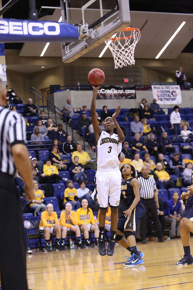 Jasmine Joyner goes for at shot during the Mocs' 78-44 romp past UNC Greensboro in the opening round of the SoCon tournament Thursday. Joyner had a career game with 22 points and 10 rebounds in only 23 minutes of play. 
