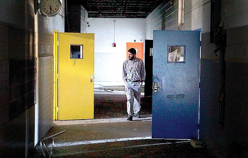 Frank Bilbrey, a safety and compliance inspector, walks through the vacant Calvin Donaldson Elementary School Annex Building which could possibly be repurposed as an early childhood learning center from low-income families.