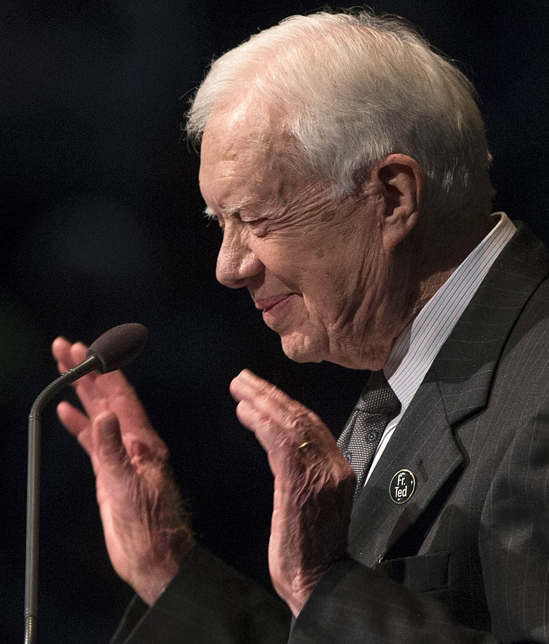 
              Former President Jimmy Carter speaks during the memorial service for the Rev. Theodore Hesburgh, Wednesday, March 4, 2015, in the Purcell Pavilion at the University of Notre Dame in South Bend, Ind. Hesburgh served as the school's president for 35 years while also promoting human rights. Hesburgh died Thursday, Feb. 26. He was at 97. (AP Photo/South Bend Tribune, Robert Franklin)
            