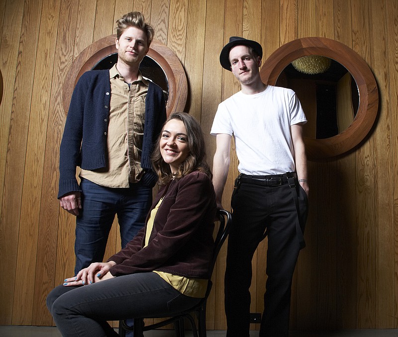 
              FILE - In this Jan. 18, 2013 file photo, from left, Wesley Schutlz, Neyla Pekarek and Jeremiah Fraites of The Lumineers pose at the Dream Downtown Hotel in New York. Fraites says that a picture of a New Jersey newspaper columnist is the secret to the bands’ success. He posted a picture of his keyboard with the picture of The Record political columnist Herb Jackson to the folk rock band’s Facebook, Instagram and Twitter accounts on Thursday, March 6, 2015. He says that he taped the picture to his keyboard 10 years ago and that “looking at him assures me creativity will flow.”  (Photo by Dan Hallman/Invision/AP, File)
            