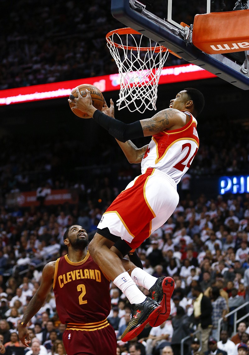 Atlanta Hawks guard Kent Bazemore (24) scores as Cleveland Cavaliers guard Kyrie Irving (2) defends during their game Friday, March 6, 2015, in Atlanta.