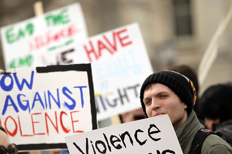 
              In this Feb. 24, 2014 photo, University of Iowa junior Patrick Took gathers with other demonstrators during a rape and violence awareness rally on the Big Ten school's campus in Iowa City, Iowa. In 2015, lawmakers in several states are seeking to address the high-profile problem of sexual assaults on college campuses, but their bills have encountered criticisms and legal complexities. Among the contentious measures, some are viewed as infringing on victims’ rights and others as too favorable to accused students. (AP Photo/Iowa City Press-Citizen, David Scrivner)
            