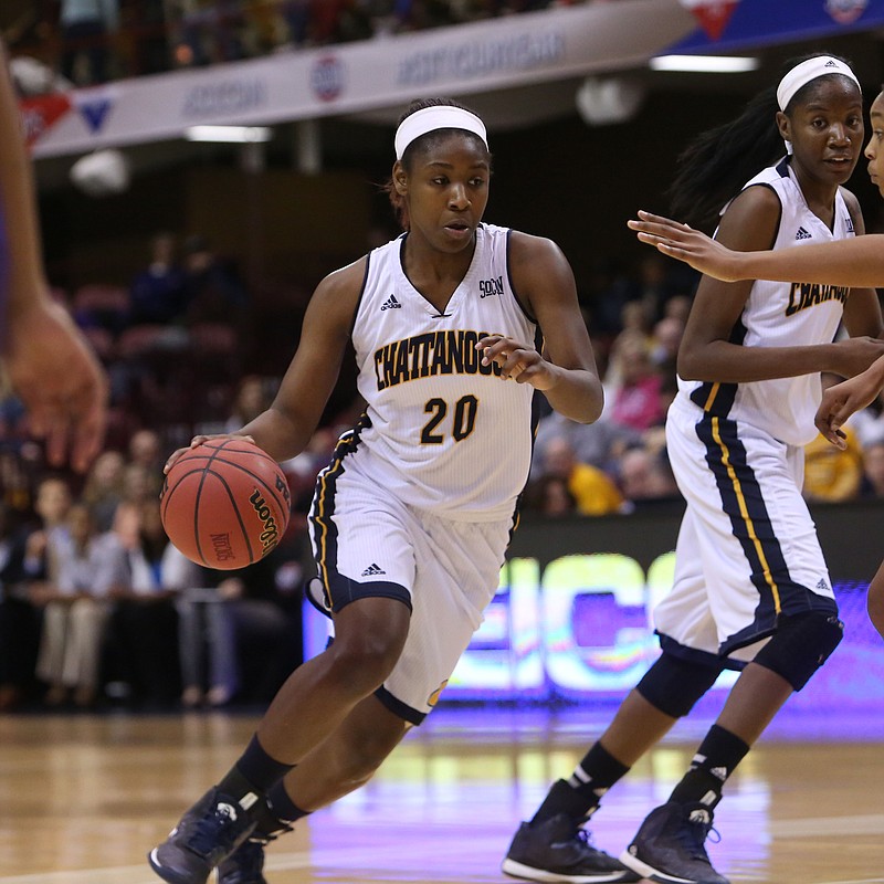 Keiana Gilbert works to get the ball past Furman's defense in their game Friday, March 6, 2015.