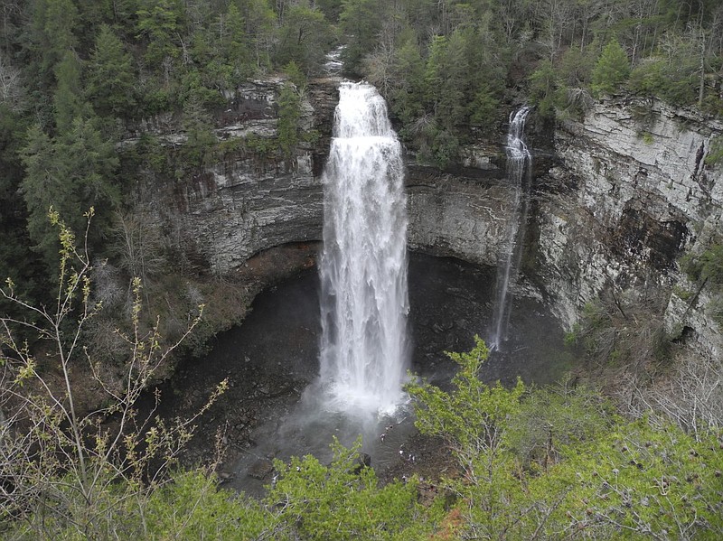A waterfall is visible from a trail at Fall Creek Falls State Park.