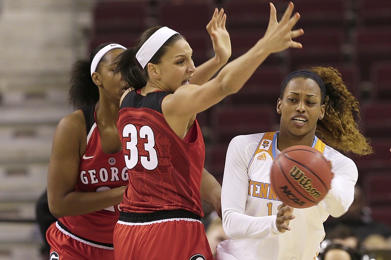 Tennessee's Bashaara Graves, right, passes the ball in front of Georgia's Mackenzie Engram (33) and Halle Washington, left, in their game in North Little Rock, Ark., Friday, March 6, 2015.