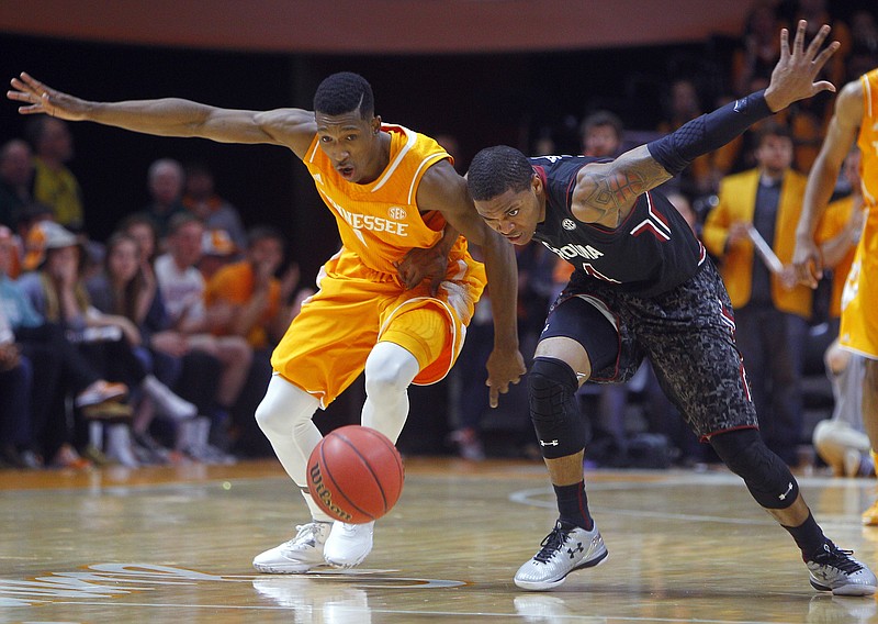Tennessee guard Josh Richardson, left, battles for a loose ball with South Carolina guard Marcus Stroman during their game Saturday, March 7, 2015, in Knoxville.