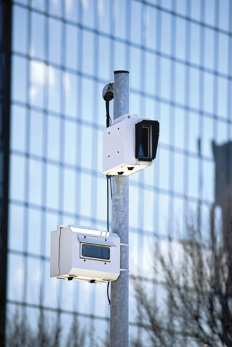 A traffic camera monitors the traffic signal on Martin Luther King Boulevard.