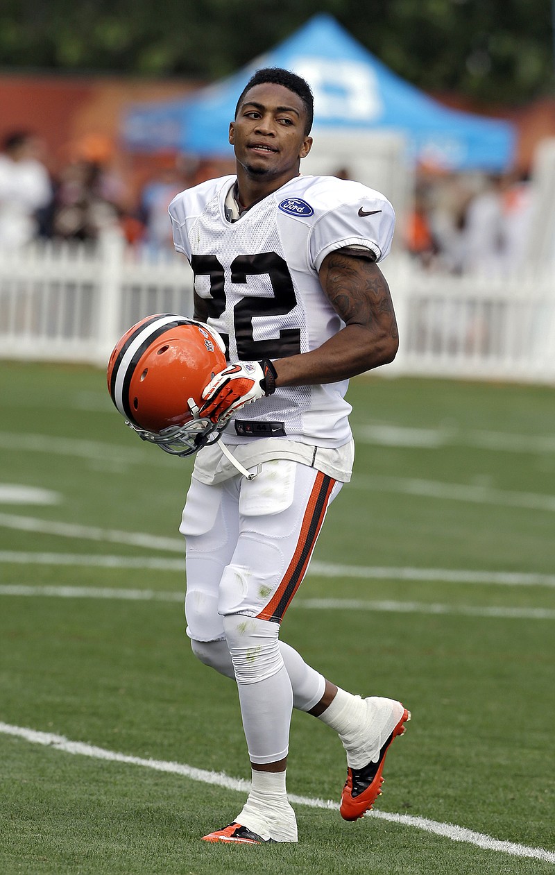 Buster Skrine, former UTC player and Cleveland Browns defensive back, now with the New York Jets, carries his helmet in this 2013 file photo.