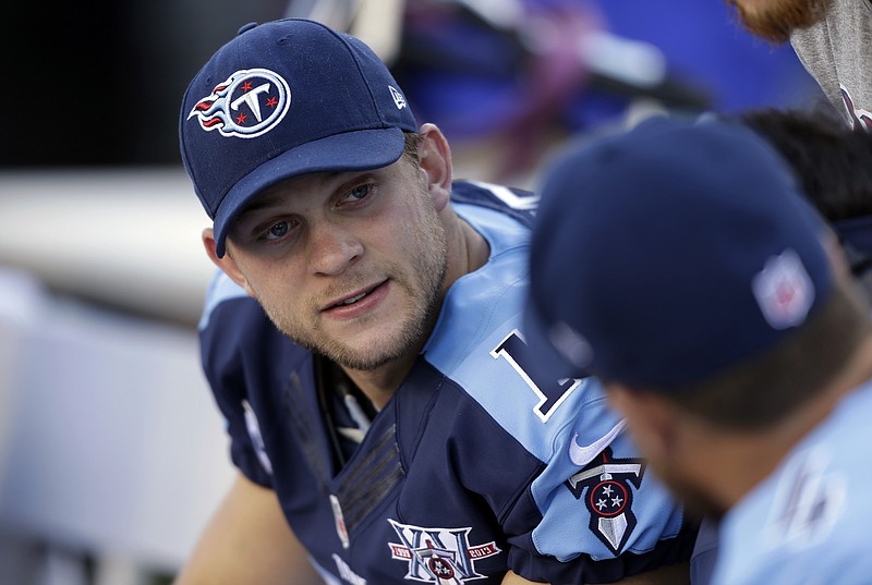 In this Oct. 20, 2013, file photo, Tennessee Titans quarterback Jake Locker talks on the sideline during the first quarter of an NFL football game against the San Francisco 49ers in Nashville.