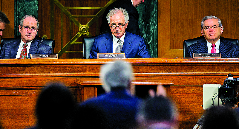 Caption/Description: Senate Foreign Relations Committee, Chairman Sen. Bob Corker, R-Tenn., center, flanked by the committee's ranking member Sen. Robert Menendez, D-NJ., right, and Sen. James Risch, R-Idaho, listens on Capitol Hill in Washington, Wednesday, March 11, 2015