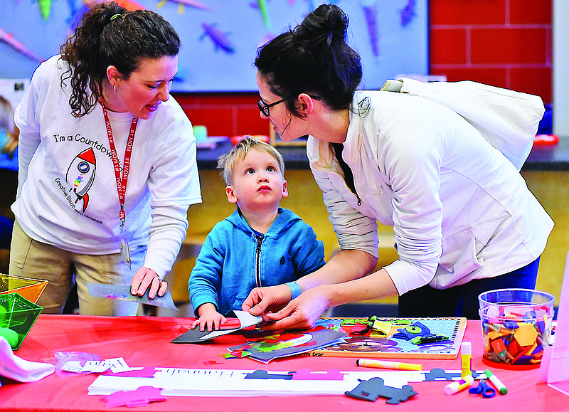 Erin Clark, from Lookout Mountain, Ga., helps her son, Auden Clark, as he works on a project at the Creative Discovery Museum on Wednesday, Mar. 11, 2015, in Chattanooga, Tenn. A news conference was held at the CDM on Wednesday to announce a new initiative, Countdown to Kindergarden, designed to help children be prepared to start school. At left is playgym educator Emily Lemons from the Creative Discovery Museum.