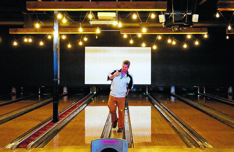 Owner John Wise walks between bowling lanes Thursday, March 12, 2015, as the Southside Social bowling alley prepares for business in Chattanooga, Tenn. The business officially opened last week.