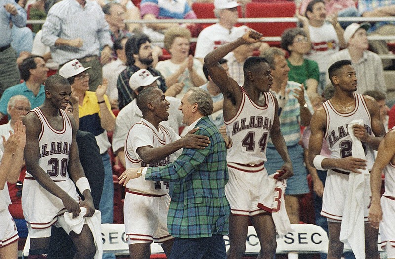 Former Alabama coach Wimp Sanderson celebrates with Crimson Tide players following their 1990 trouncing of Ole Miss in the SEC tournament final in Orlando.