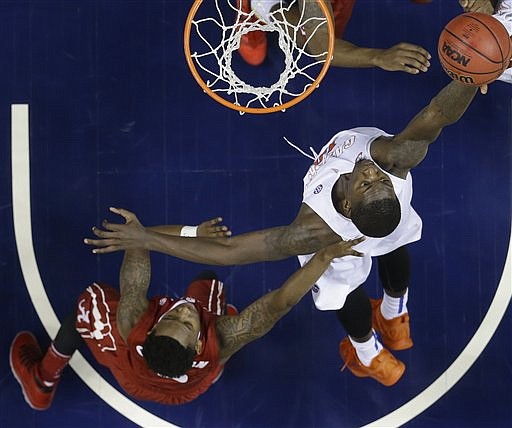 Florida forward Dorian Finney-Smith (10) shoots over Alabama guard Justin Coleman (5) during the second half of an NCAA college basketball game in the second round of the Southeastern Conference tournament, Thursday, March 12, 2015, in Nashville, Tenn. Florida won 69-61. (AP Photo/Mark Humphrey)