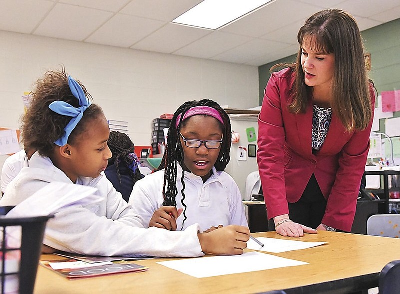 Tennessee Education Commissioner Candice McQueen, right, talks with sixth-grade English Language Arts students Deshay Smith, left, and Carlotta Sawyer Friday at  Dalewood Middle School.