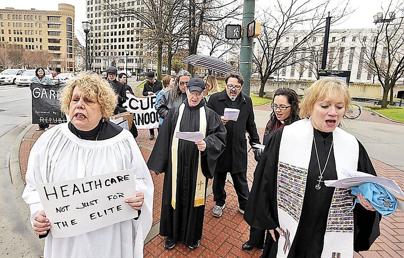 Vivian Dodds, left, and Kate Stulce, right, lead the way to State Sen. Todd Gardenhire's office during Compassionate Friday, organized by the Mercy Junction Justice and Peace Center, with additional action from Occupy Chattanooga.