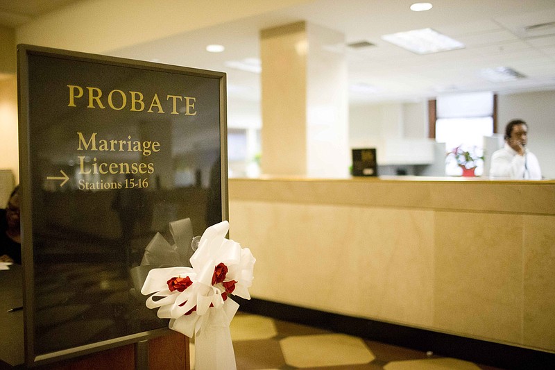 The Birmingham Probate Court sign shows a ribbon welcoming couples to get a marriage license Wednesday, March 4, 2015, in Birmingham, Ala.