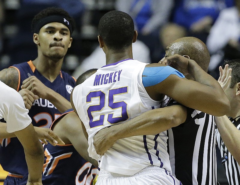 Auburn forward Jordon Granger (25) backs away from LSU forward Jordan Mickey (25) after Granger hit LSU guard Tim Quarterman during the second half of an NCAA college basketball game in the quarterfinal round of the Southeastern Conference tournament Friday, March 13, 2015, in Nashville.