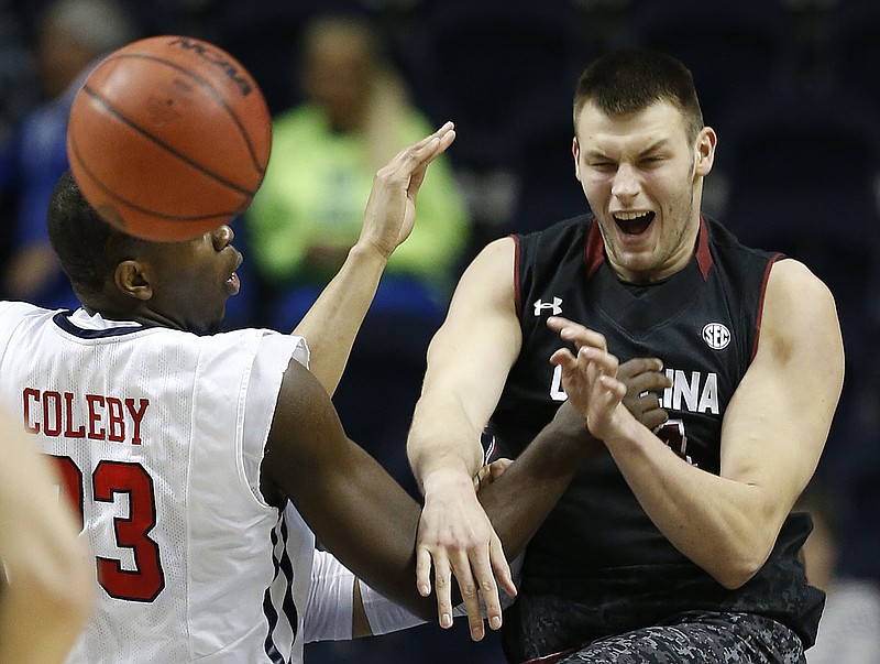 South Carolina forward Laimonas Chatkevicius (14) passes the ball as Mississippi center Dwight Coleby (23) during the second half of an NCAA college basketball game in the second round of the Southeastern Conference tournament Thursday, March 12, 2015, in Nashville.