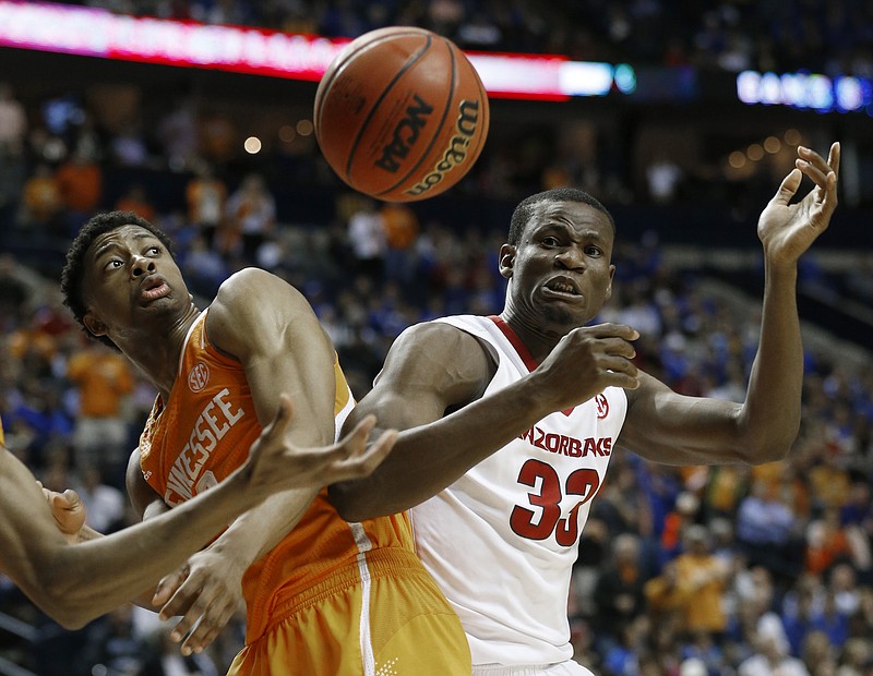 Arkansas forward Moses Kingsley (33) loses the ball against Tennessee guard Robert Hubbs III (3) during the second half of an NCAA college basketball game in the quarterfinal round of the Southeastern Conference tournament Friday, March 13, 2015, in Nashville.