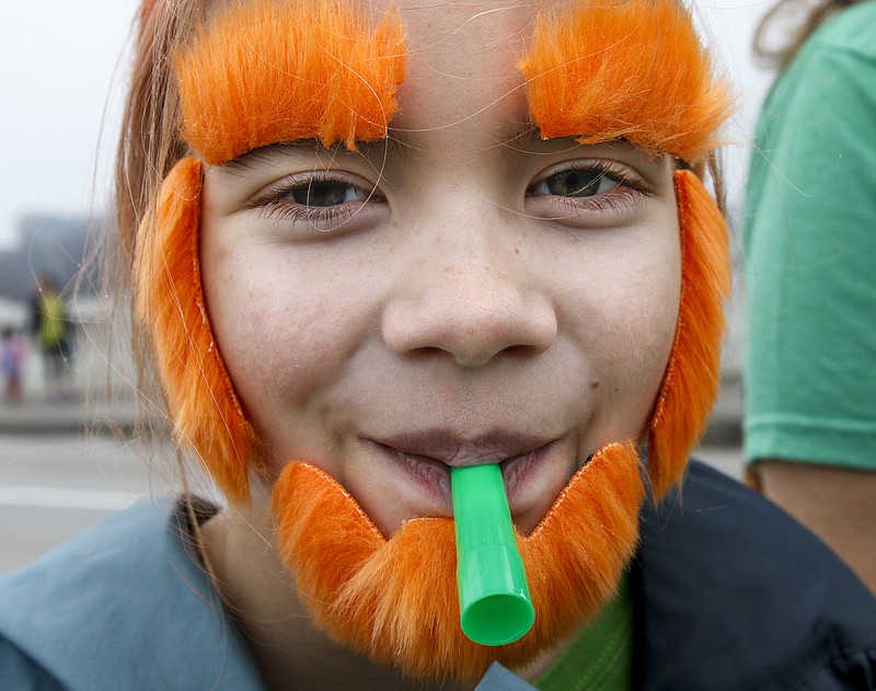 Lily Petree wears a false orange beard and eyebrows while marching in the St. Chatty's Day Parade on Friday, March 14, 2015, in Chattanooga.