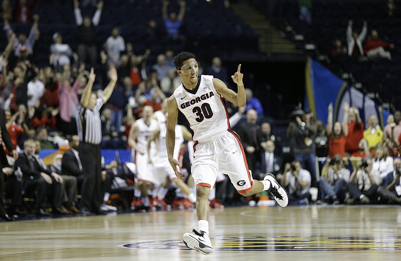 Georgia guard J.J. Frazier (30) celebrates his three-point shot against South Carolina during the second half of an NCAA college basketball game in the quarterfinal round of the Southeastern Conference tournament Saturday, March 14, 2015, in Nashville. Georgia won 74-62.