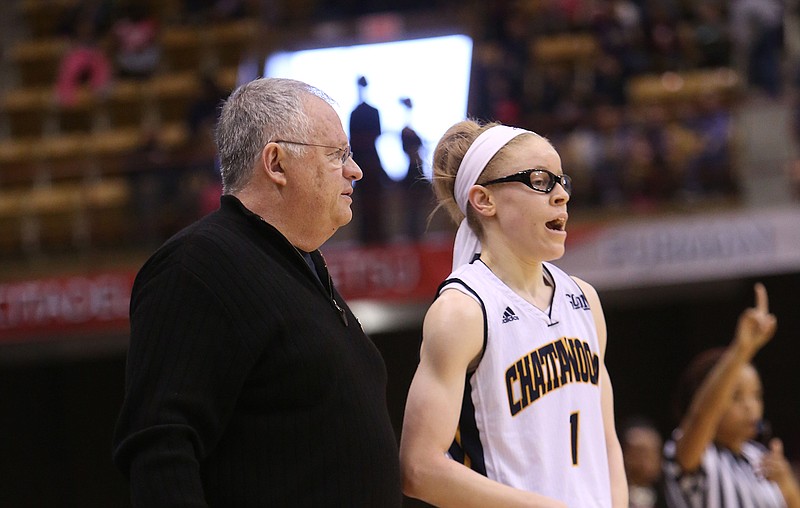 UTC coach Jim Foster and Alicia Payne talk during the second round of the SoCon tournament Friday, March 6, 2015. The Mocs beat Furman 68-55.