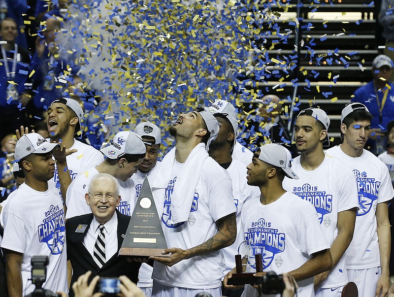 Kentucky forward Willie Cauley-Stein holds the trophy after the NCAA college basketball Southeastern Conference tournament championship game against Arkansas on Sunday, March 15, 2015, in Nashville. Kentucky won 78-63.