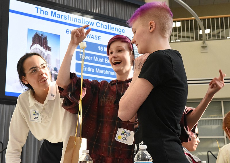 Chattanooga High School Center for Creative Arts student Lili Strider, center, reacts after building a freestanding structure in the marshmallow challenge Monday at Unum's Tech Night. Assisting Strider are Girls Preparatory School student Hope Newberry, left, and CCS student Zan Strider. The annual event is sponsored by Unum to give students a chance to learn about careers in the IT sector.