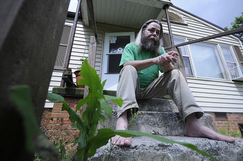 Boyd Green, 58, sits on the front steps at his home in Rocky Face, Ga. Green is a disabled United States Marine disturbed by Whitfield County police after several recent encounters. 