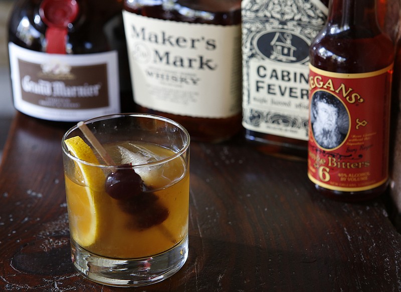 An orange maple old fashioned Halloween cocktail is seen with its ingredients Friday, Oct. 24, 2014, at Urban Stack Restaurant in Chattanooga.