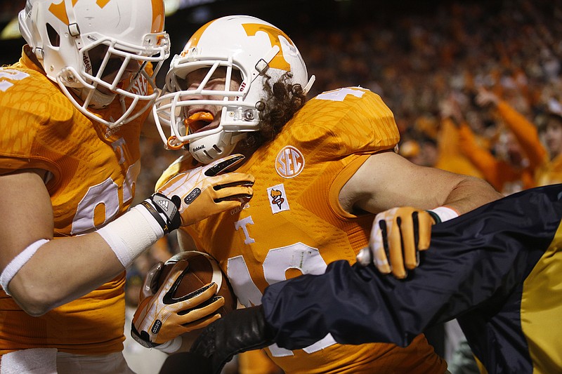 Tennessee tight end Ethan Wolf, left, celebrates with tight end Alex Ellis after Ellis ran in a fake field goal for a touchdown during the Vols' football game against the Missouri Tigers on Saturday, Nov. 22, 2014, at Neyland Stadium in Knoxville.